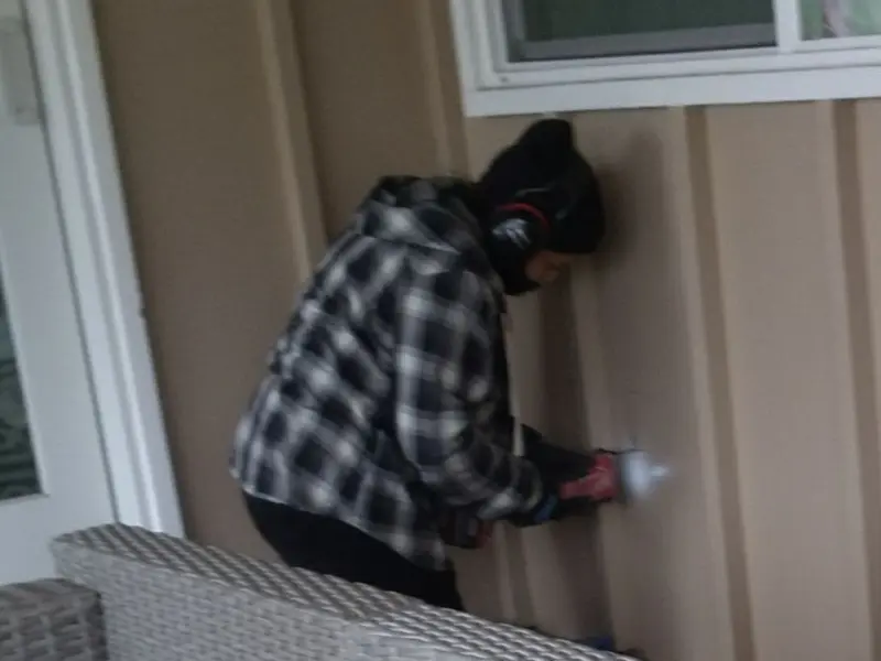 Professional electrician installing an exterior outlet in Jericho